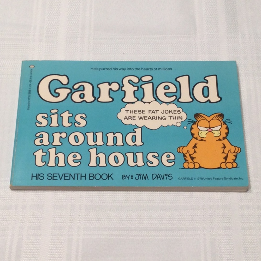 Garfield sits around the house by Jim Davis